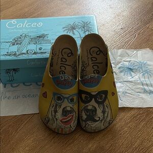 Calceo Women's Yellow Graphic Dog Clog Mules